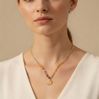 Seraphina Treasures gold-tone necklace with colorful beads and a sun pendant. A radiant piece for warmth and hope.