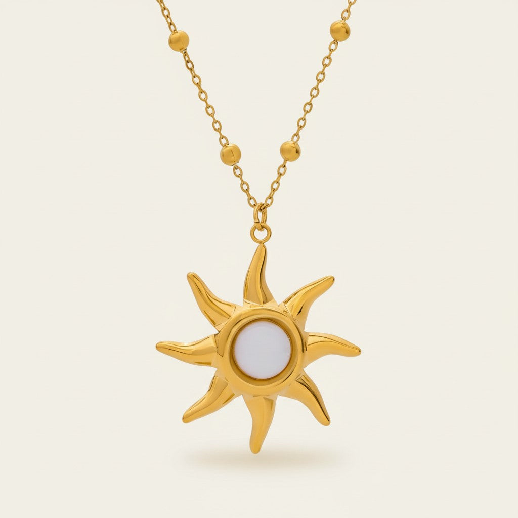 Seraphina Treasures gold sun necklace with white opal center and beaded chain. Celestial-inspired jewelry.