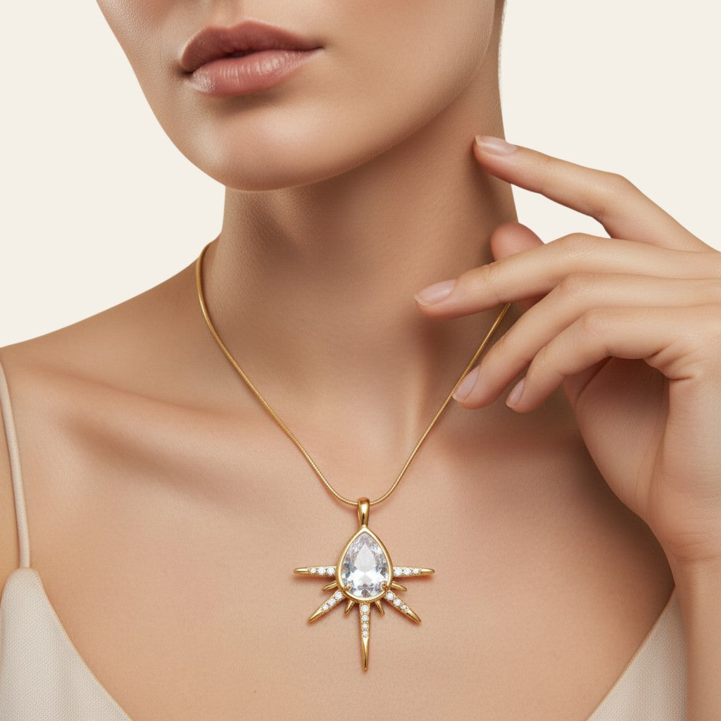 Seraphina Treasures gold teardrop necklace with cubic zirconia sunburst pendant. Elegant and sparkling.