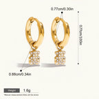 Seraphina Treasures gold-tone hoop earrings with sparkling cubic zirconia teddy bear charms. Waterproof and hypoallergenic.