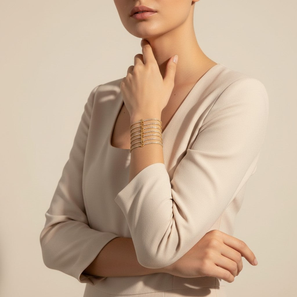 Seraphina Treasures gold tennis bracelet with letter pendant and clear zirconia stones, worn on a woman's wrist.