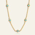 Seraphina Treasures gold necklace with turquoise stones and clear crystals, vintage-inspired design.