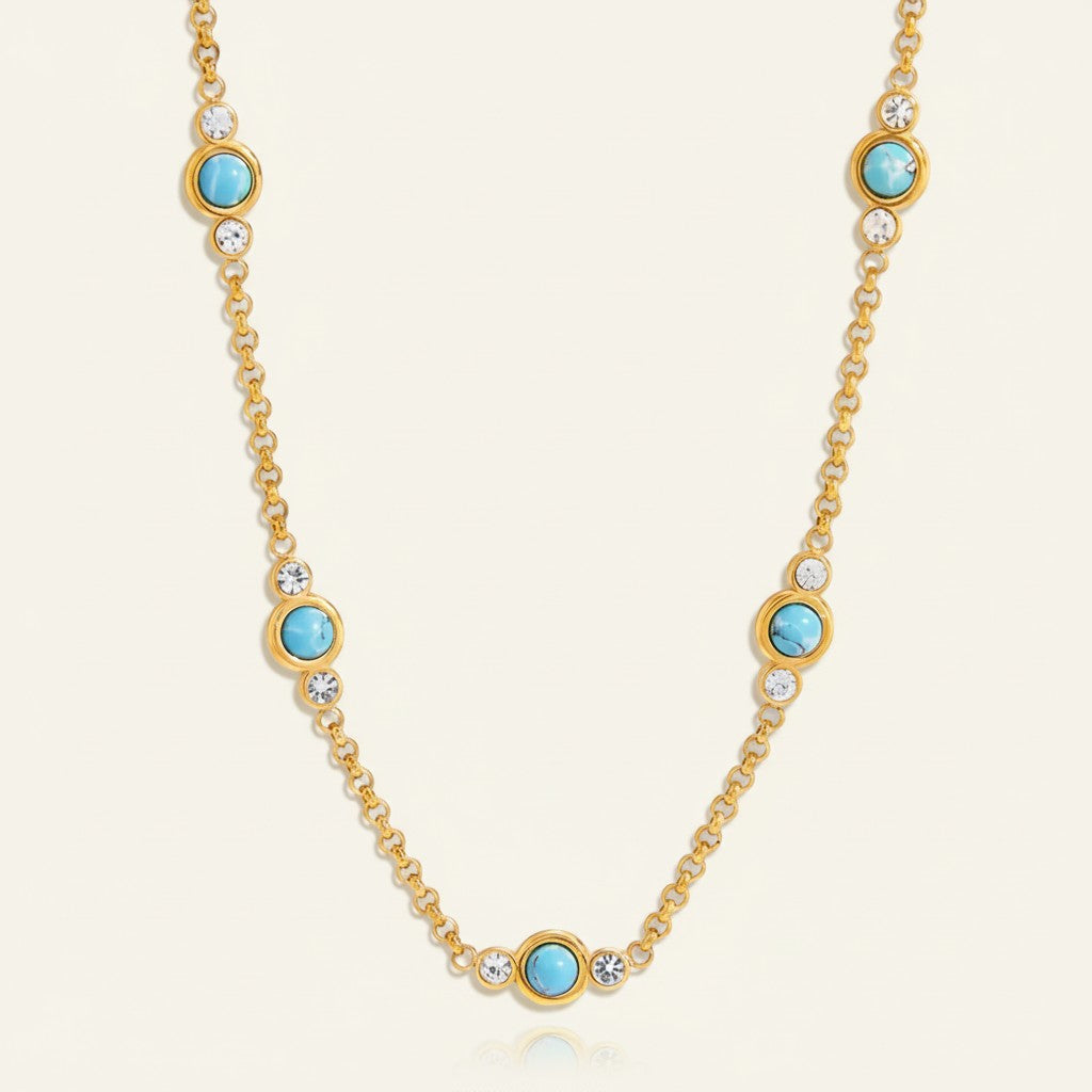Seraphina Treasures gold necklace with turquoise stones and clear crystals, vintage-inspired design.
