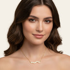 Seraphina Treasures gold wave necklace with clear crystals, elegant and versatile.