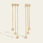 Seraphina Treasures gold plated earrings with three sparkling zircon pendants on delicate long chains, cascading design.