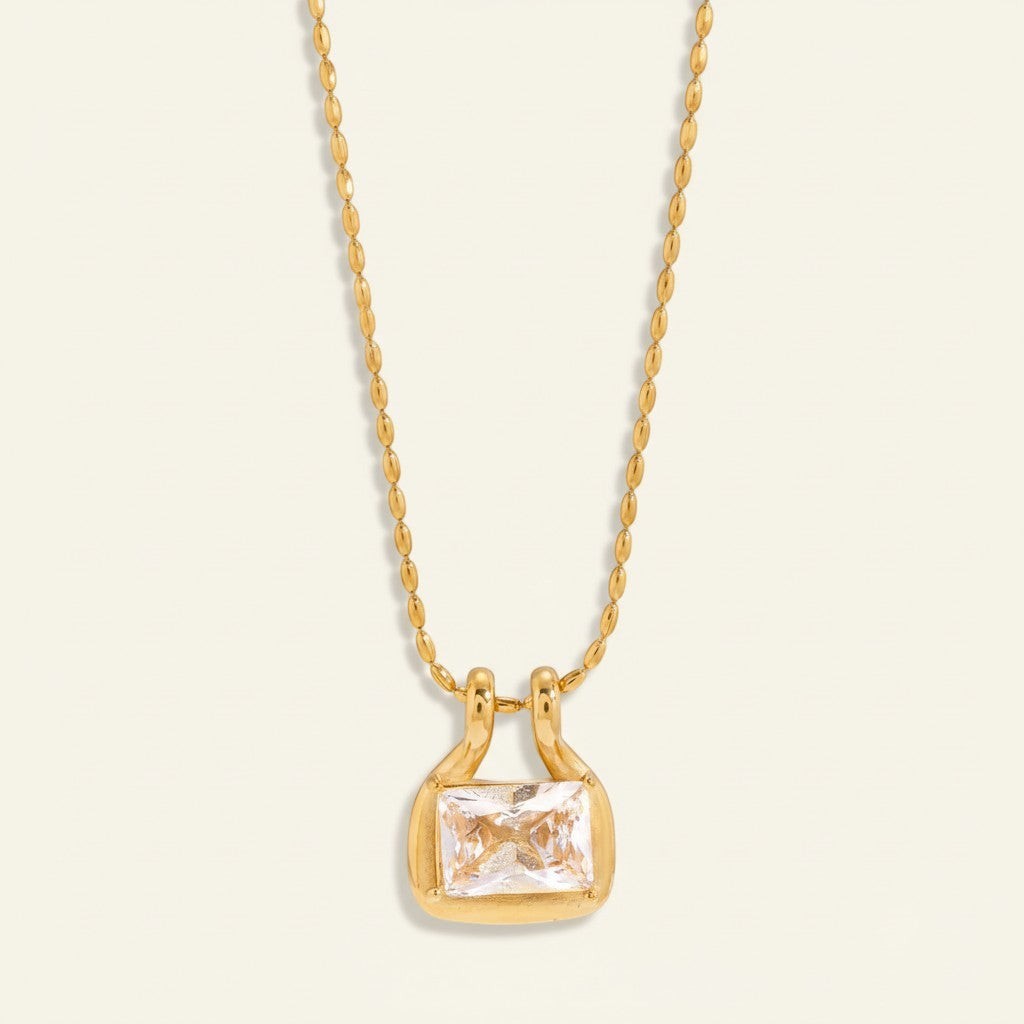 Seraphina Treasures gold necklace with a rectangular clear zircon pendant and a beaded chain.