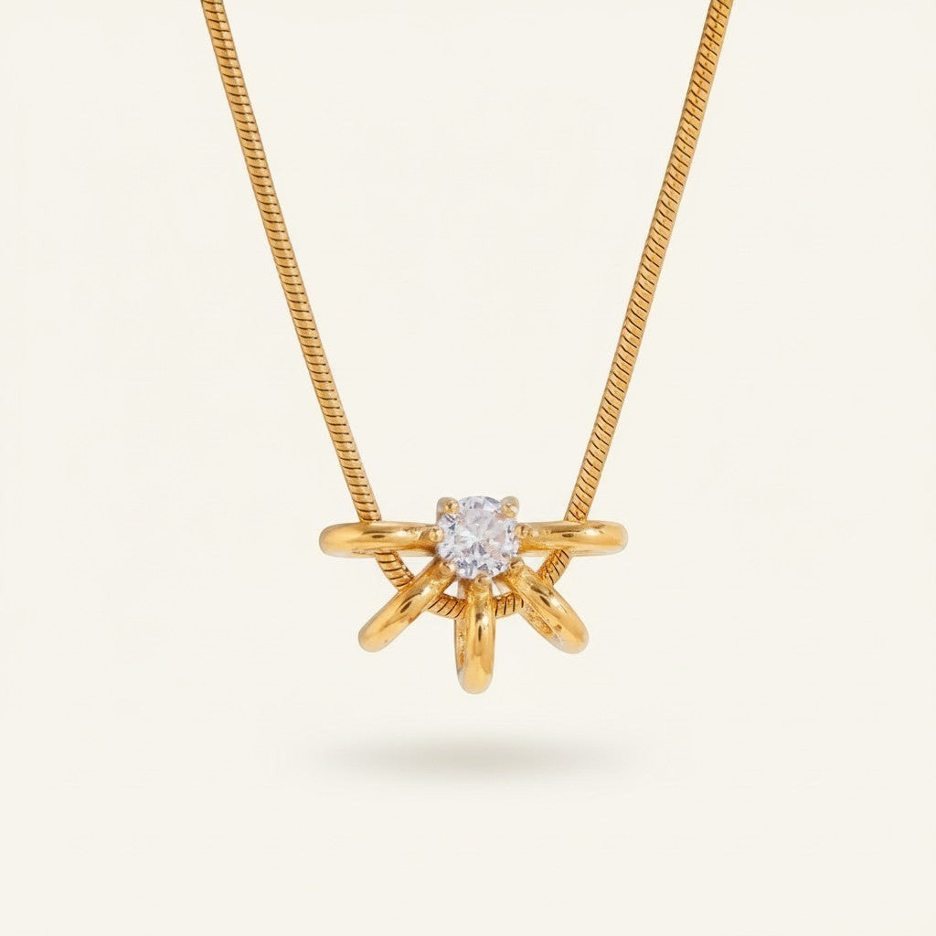 Seraphina Treasures gold necklace with a central clear zircon stone surrounded by a hollow circle design with delicate gold spokes.
