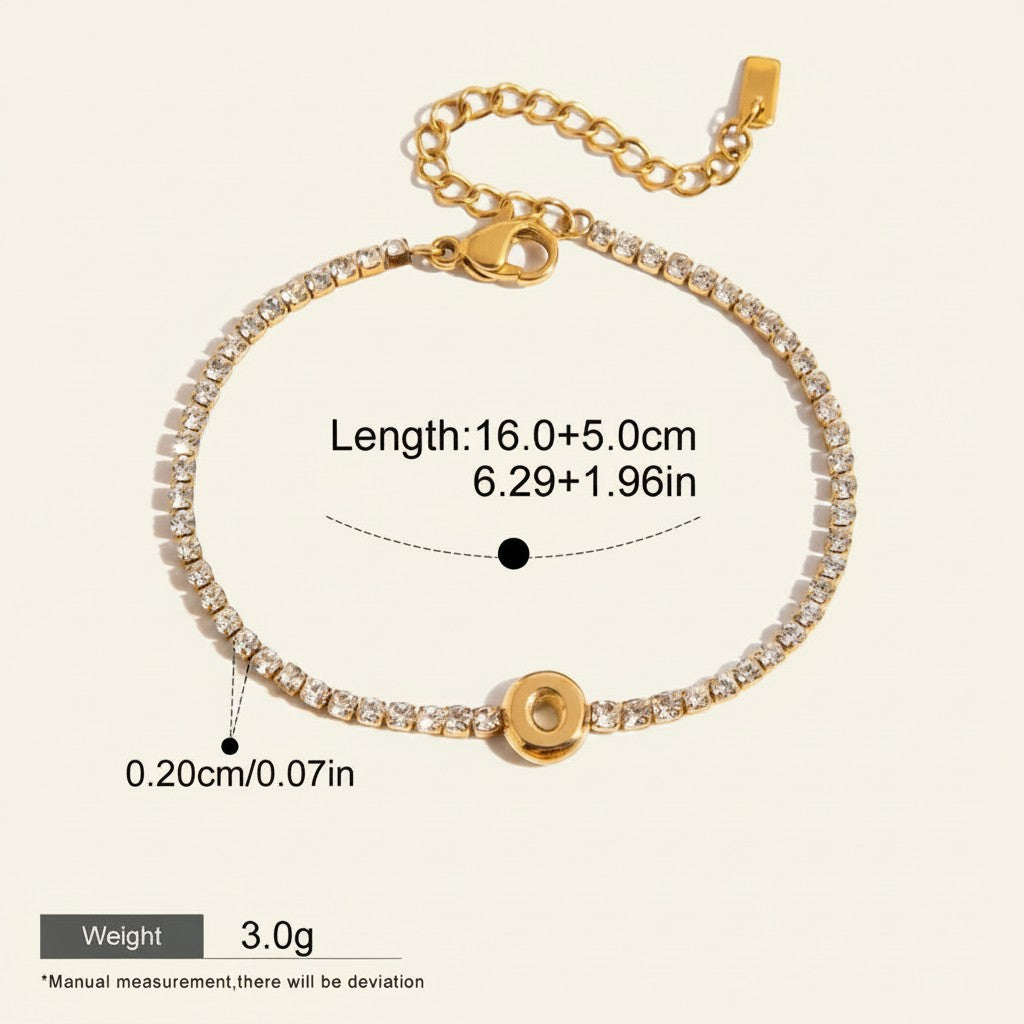 Seraphina Treasures gold-tone bracelet with clear zirconia stones and a circular initial pendant, adjustable length.