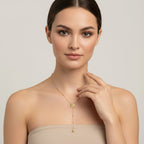 Seraphina Treasures Grainne gold necklace with sun pendant and bead accents, worn by a model.