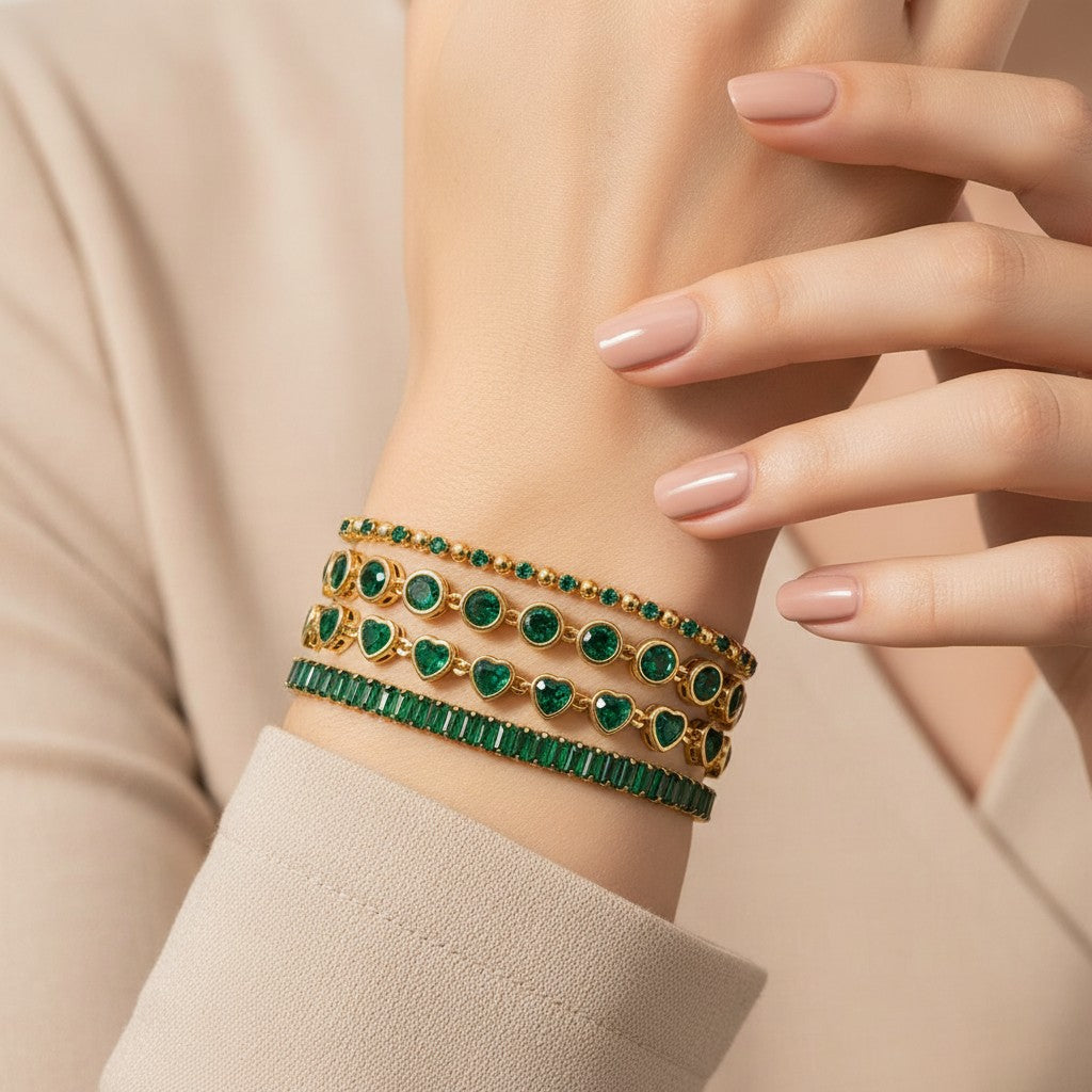 Seraphina Treasures gold bracelets with green zirconia stones in round, heart, and baguette cuts. Accented with clear stones.