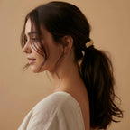 Seraphina Treasures Leonora gold hammered metal hair clip with a unique texture, securing dark brown hair.