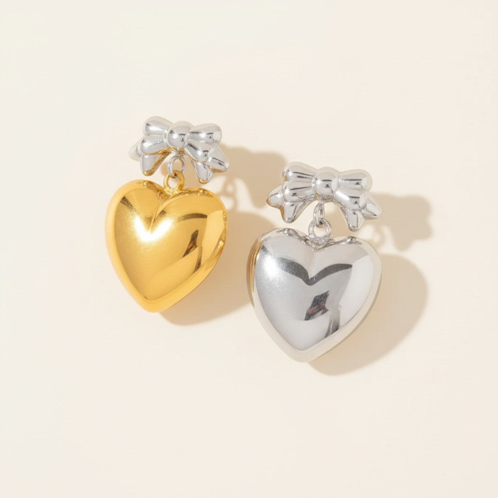Seraphina Treasures Zaleira gold and silver heart earrings with bowknot detail.