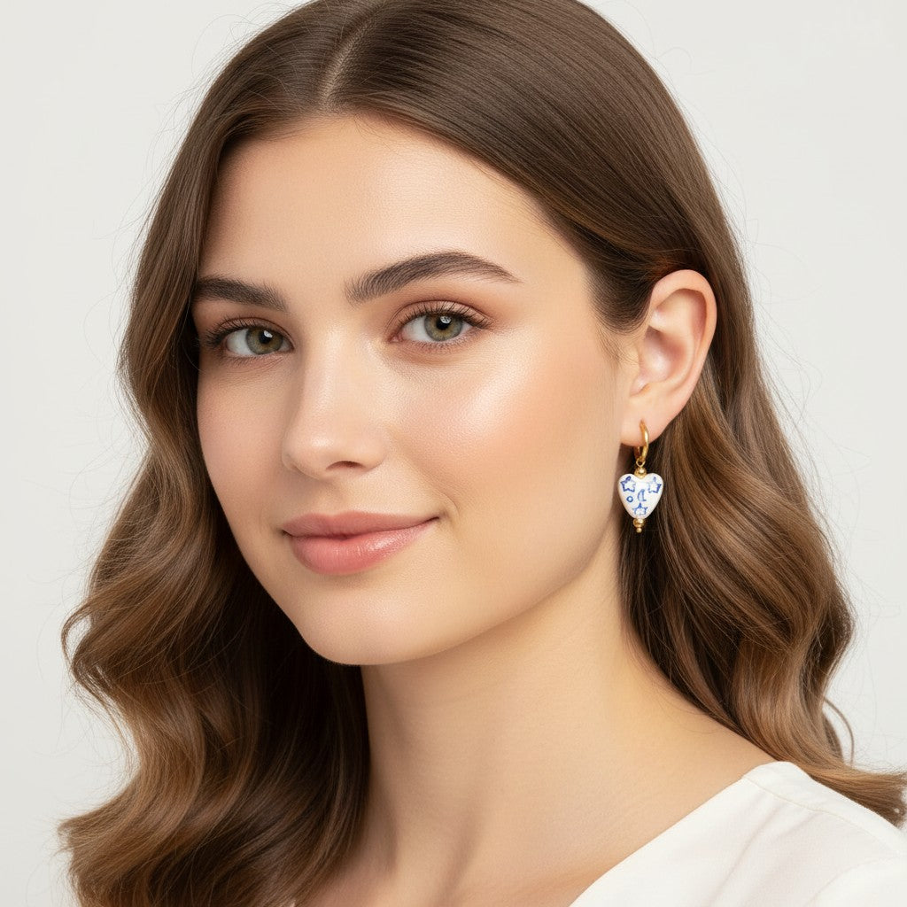 Seraphina Treasures white heart earrings with blue stars and moons, gold hoop and beads.