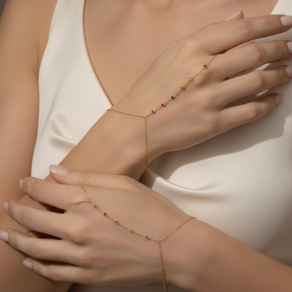 Seraphina Treasures Hecate bracelet with colorful zircon accents, connecting the wrist to the finger.
