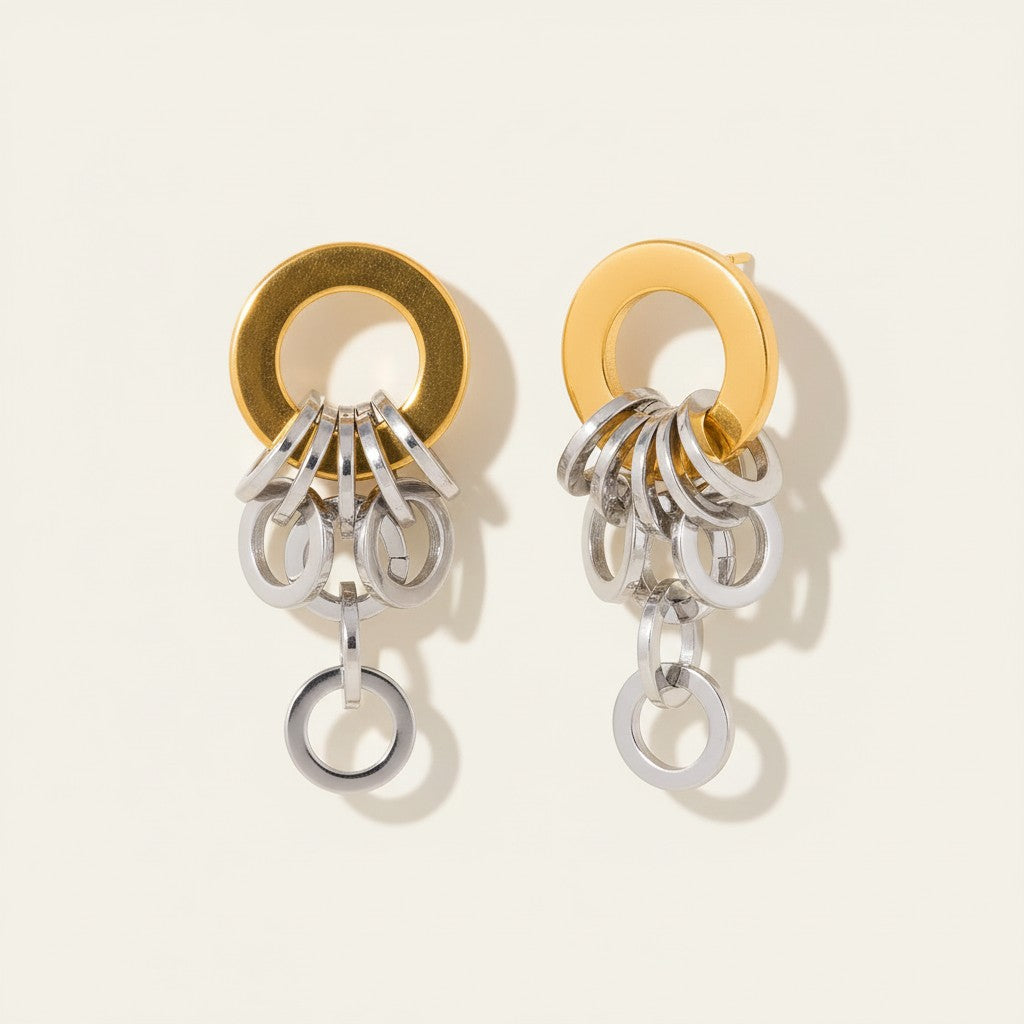 Seraphina Treasures Ianthos gold and silver tone metal hoop earrings with dangling chain links.