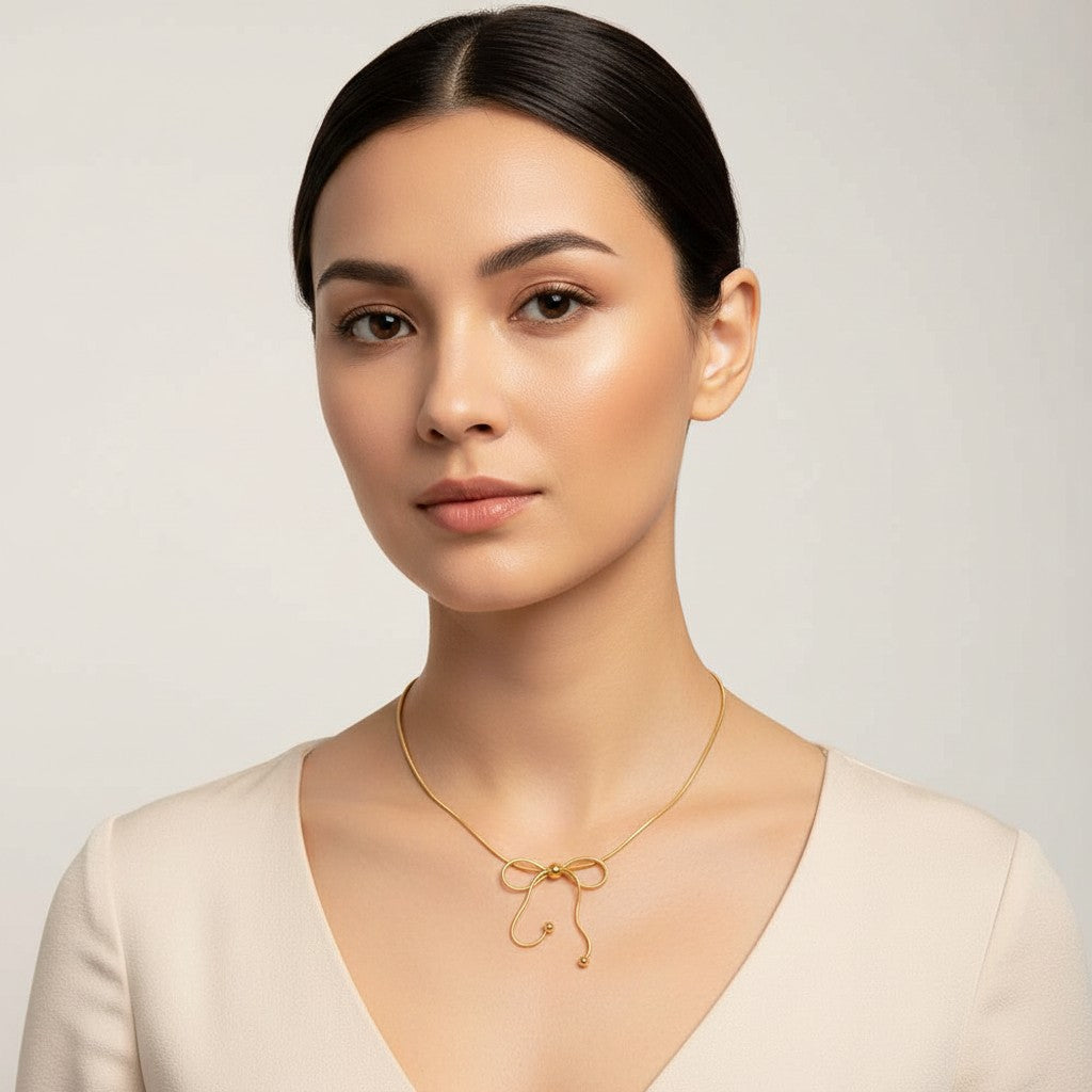 Seraphina Treasures Isara gold necklace with a bow design and adjustable chain. Delicate and elegant.
