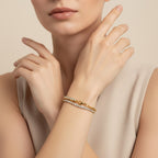 Seraphina Treasures Ithela bracelet with two delicate gold chains adorned with shimmering stones. Worn on a woman's wrist.
