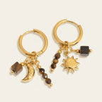 Seraphina Treasures Kalynestra gold hoop earrings with tiger eye beads, crescent moon, sun, and square charms.