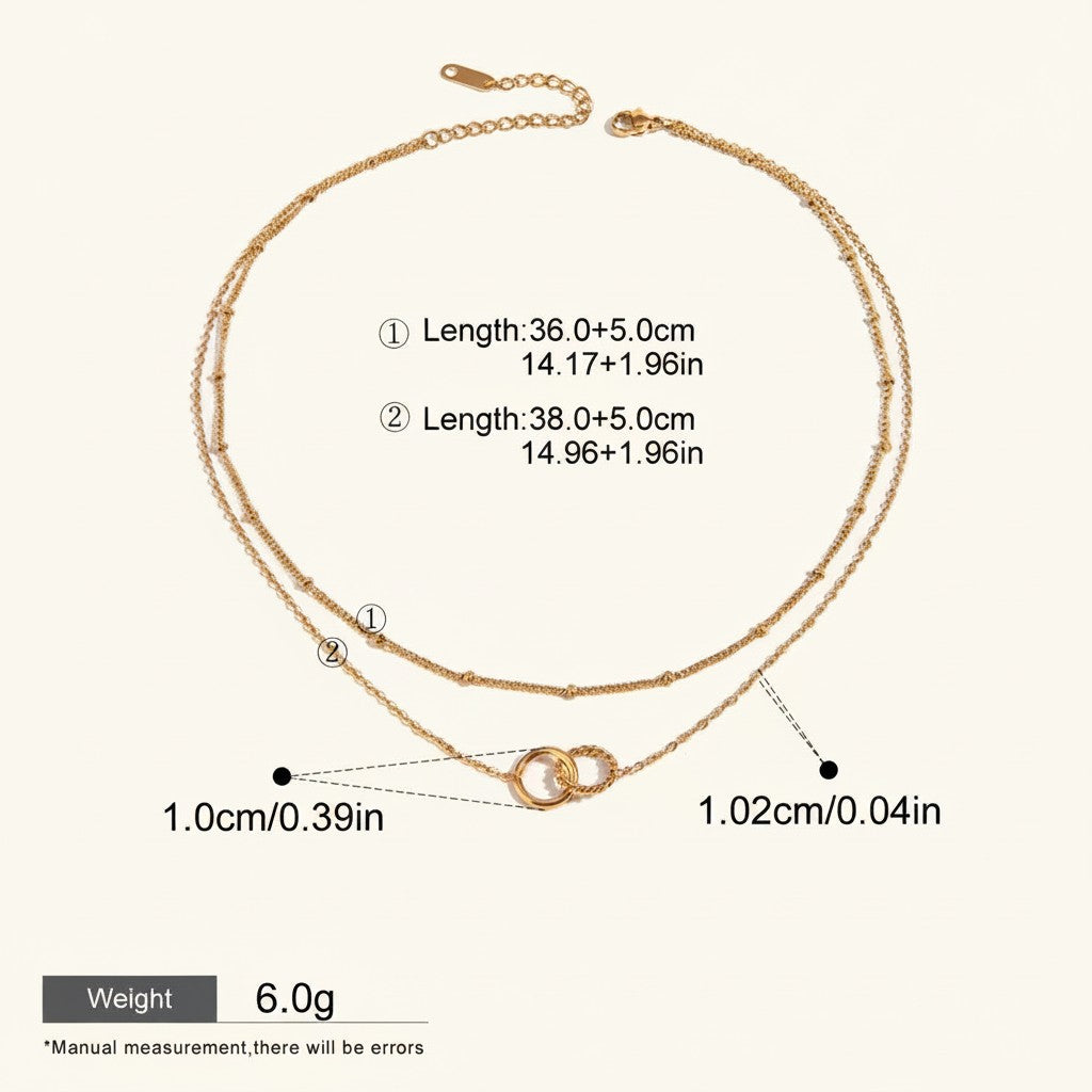 Seraphina Treasures Keeva gold-tone double chain necklace with interlocking rings pendant. Adjustable length.