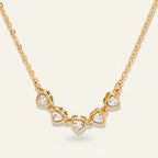 Seraphina Treasures Keturah necklace with five sparkling cubic zirconia hearts on a gold chain.