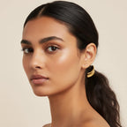 Seraphina Treasures Khepri gold-plated hair tie with a black elastic band and a curved, polished gold accent.