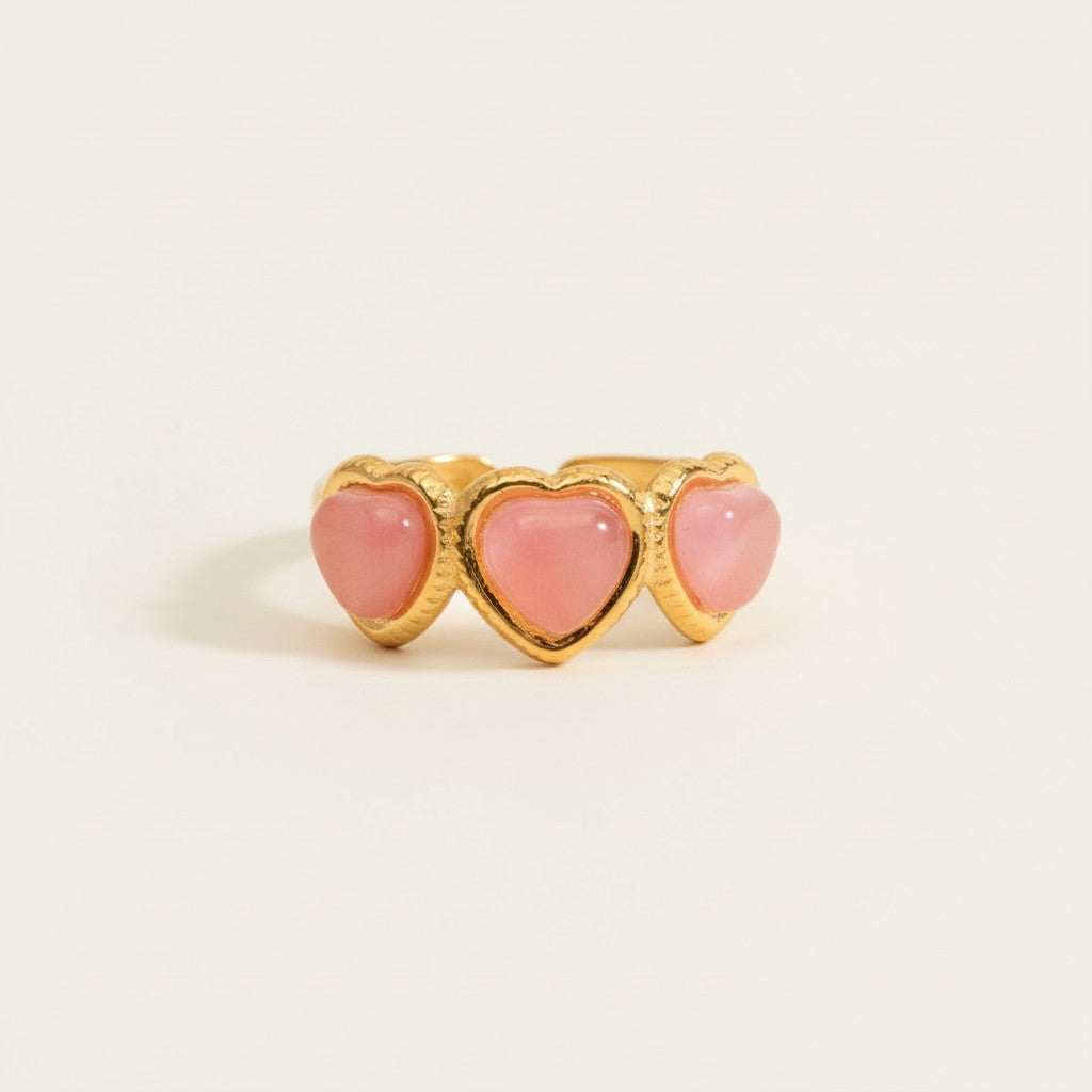 Seraphina Treasures Koralyne ring with three pink heart-shaped stones set in gold-tone metal.