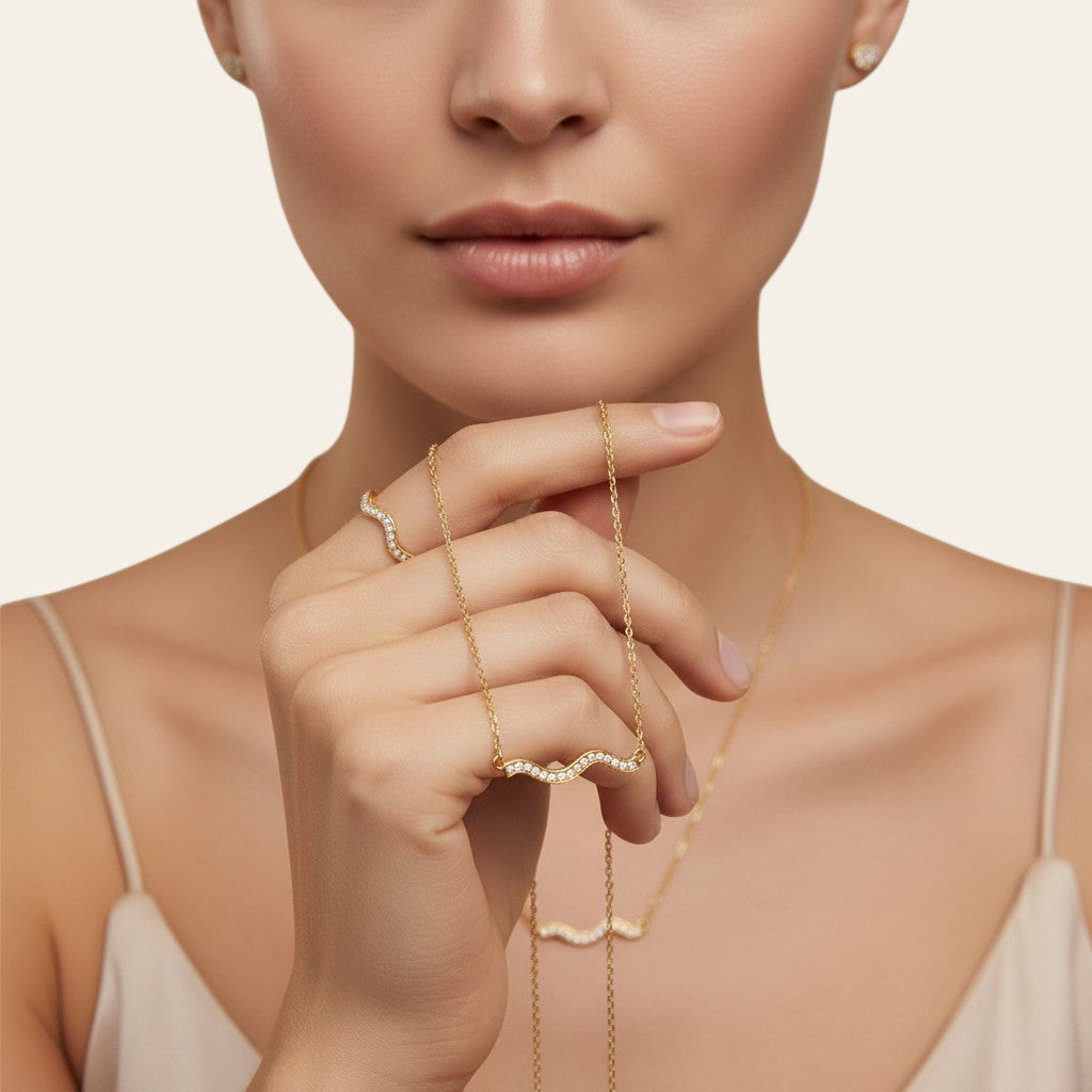 Seraphina Treasures Koralyth gold wave necklace with crystal accents.