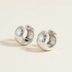 Seraphina Treasures Korvannis silver-tone metal clip-on earrings with a bold, rounded design and secure spring mechanism.