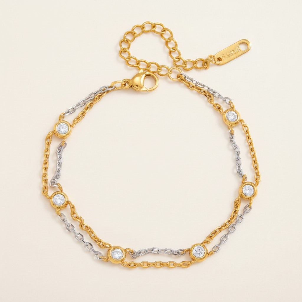 Seraphina Treasures Kymara bracelet with dual gold and silver chains adorned with round zircons. Elegant mixed metal design.