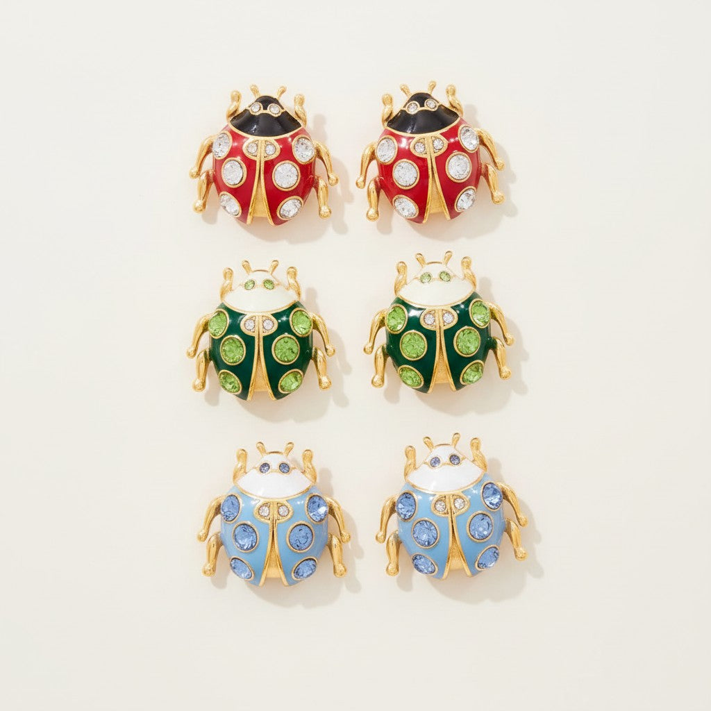 Seraphina Treasures ladybug earrings in red, green, and blue with shimmering zircon accents and gold-tone details.