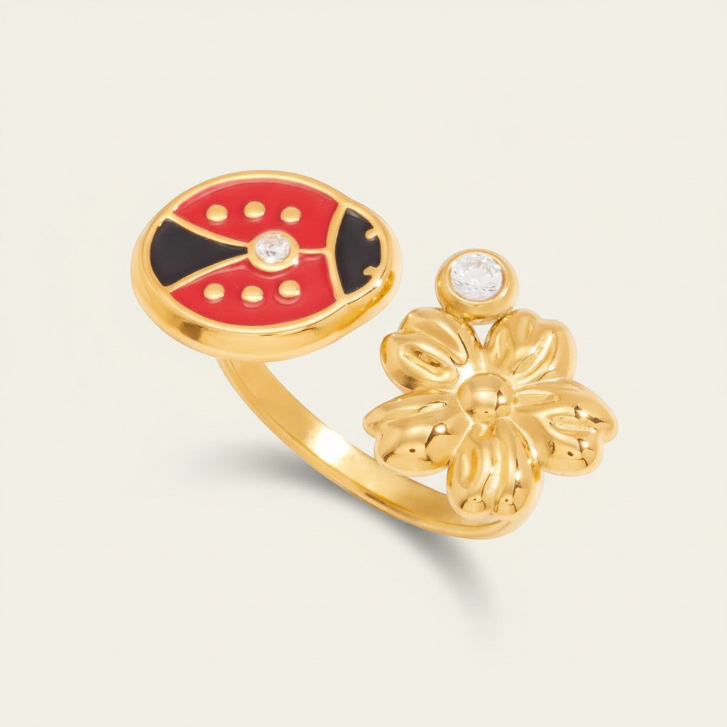 Seraphina Treasures gold adjustable ring with red ladybug, flower, and zircon accents. Oil-drip finish.