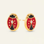 Seraphina Treasures ladybug stud earrings in red, black, and gold with a clear zircon stone. Artistic oil drip finish.