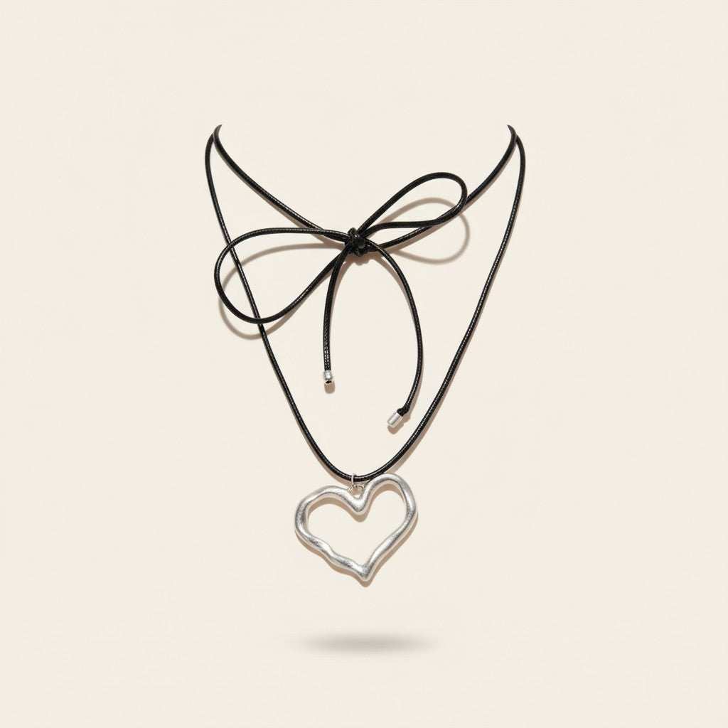 Seraphina Treasures Laurentia necklace with silver heart pendant on black waxed rope, tied with a bow.