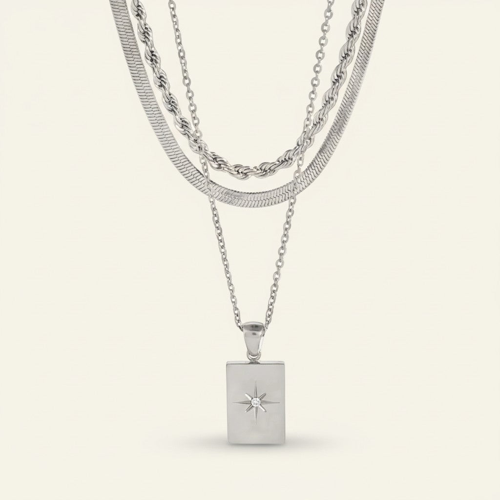 Seraphina Treasures Gaianyx layered silver necklace with geometric pendant and starburst detail.