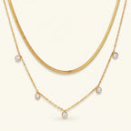 Seraphina Treasures Meliorael layered gold necklace with sparkling cubic zirconia pendants and a flat snake chain.