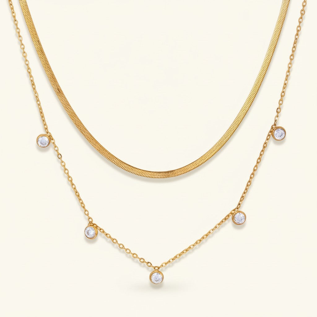 Seraphina Treasures Meliorael layered gold necklace with sparkling cubic zirconia pendants and a flat snake chain.