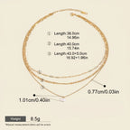 Seraphina Treasures Yasira layered gold necklace with natural pearl pendant. Features three delicate chains of varying lengths.