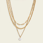 Seraphina Treasures Yasira layered gold necklace with a single pearl pendant. Features multiple chain styles.