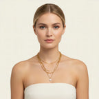 Seraphina Treasures Yasira layered gold necklace with a single pearl pendant. Features delicate chains of varying styles.