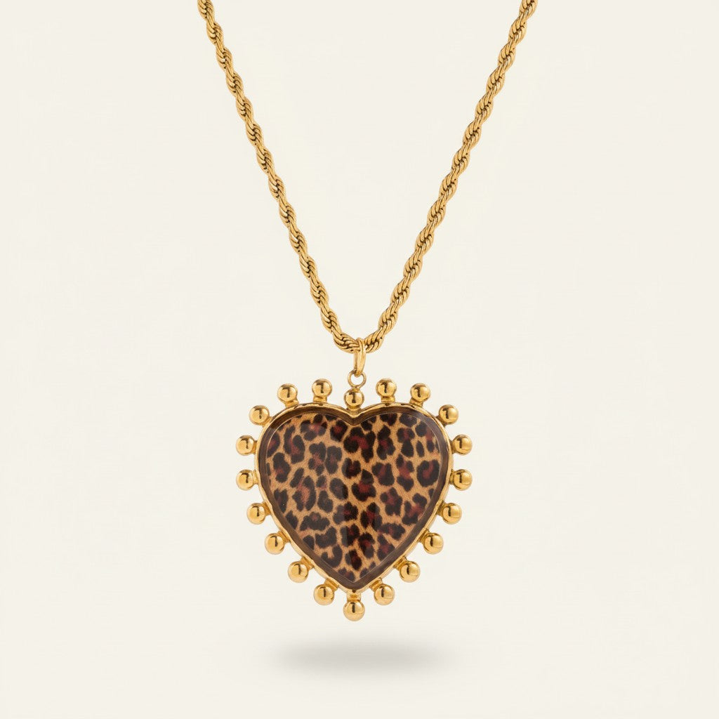 Seraphina Treasures gold necklace with a heart-shaped leopard print pendant surrounded by small gold beads.