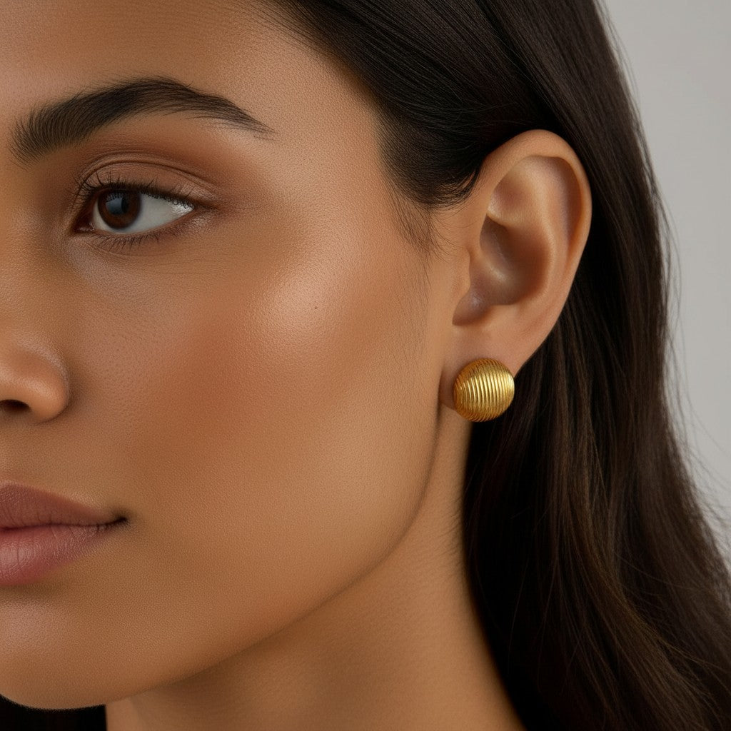 Seraphina Treasures Lyraea Earrings: gold-tone metal stud earrings with a ribbed, textured finish.