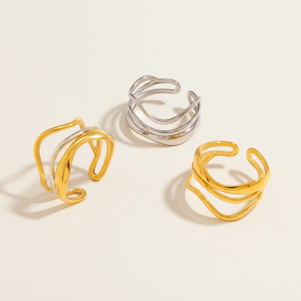 Seraphina Treasures Lyre rings in gold and silver, featuring layered, flowing, open designs for versatile stacking and modern style.