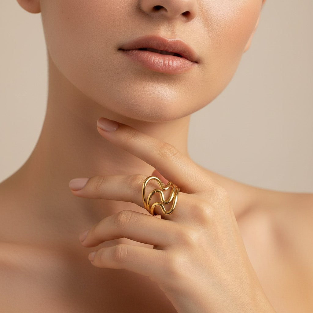 Seraphina Treasures Lyrica gold ring with irregular open design and glossy ripple texture.