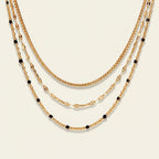 Seraphina Treasures Magnolia layered gold necklace with black beads. Elegant, modern design.