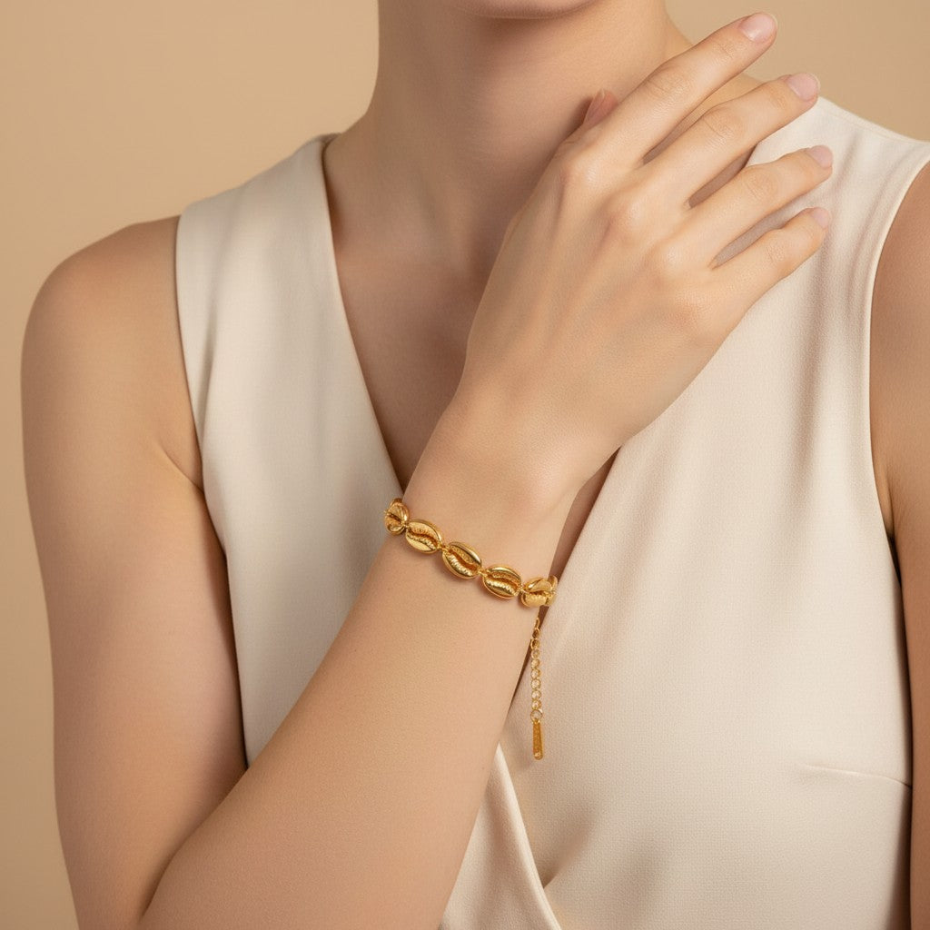 Seraphina Treasures Medea gold tone bracelet with open shell charms and adjustable chain.