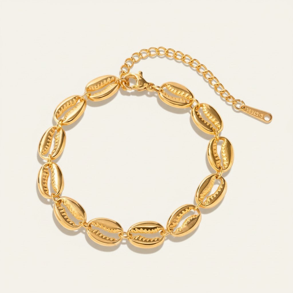 Seraphina Treasures Medea gold tone bracelet with shell charms and adjustable clasp.