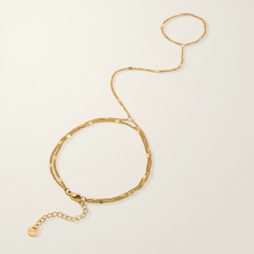 Seraphina Treasures Melia gold-tone bracelet to finger chain with delicate double strands and adjustable clasp.