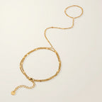 Seraphina Treasures Melia gold-tone bracelet to finger chain with delicate double strands and adjustable clasp.