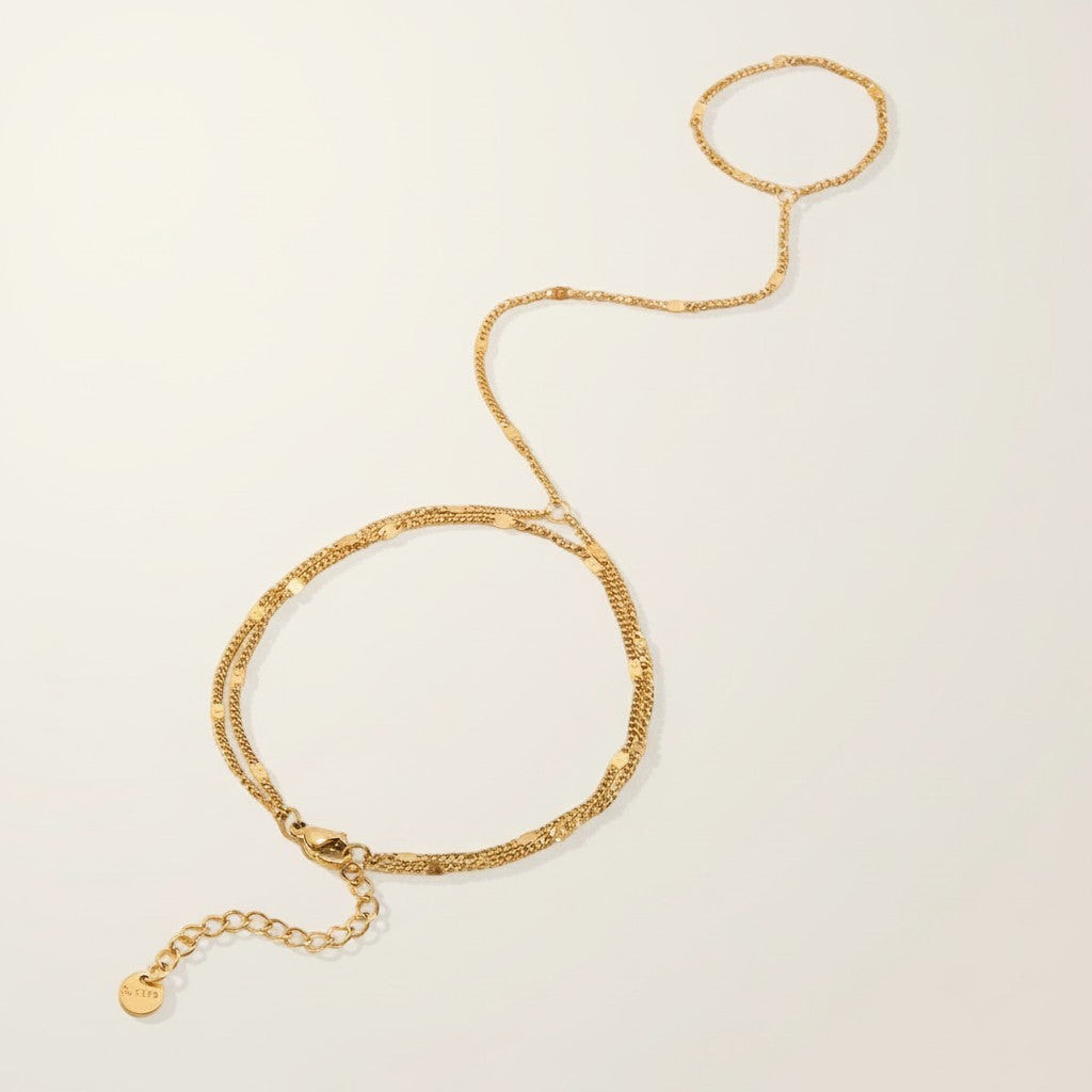 Seraphina Treasures Melia gold-tone bracelet to finger chain with delicate double strands and adjustable clasp.