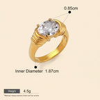 Seraphina Treasures Meliora gold ring with a large oval clear cubic zirconia stone and ribbed band detail.